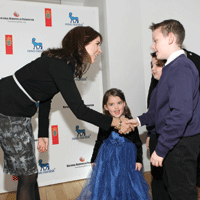 Crown Princess Mary Elizabeth bends down to shake hand with Christopher Ambrosia and his siblings