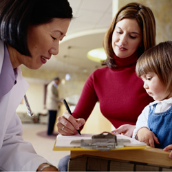 Doctor with mom and little girl at a hemophilia treatment center