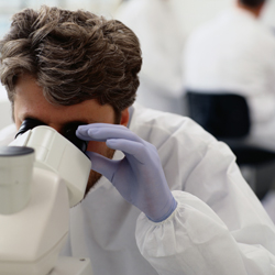 Man looking through microscope