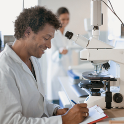 Scientist at microscope