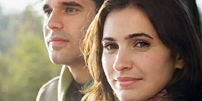 Couple sitting on bench, dating.