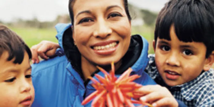 Mother and sons holding flower