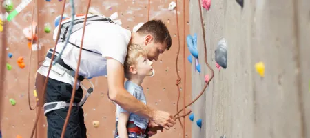 Dad and son rock climb